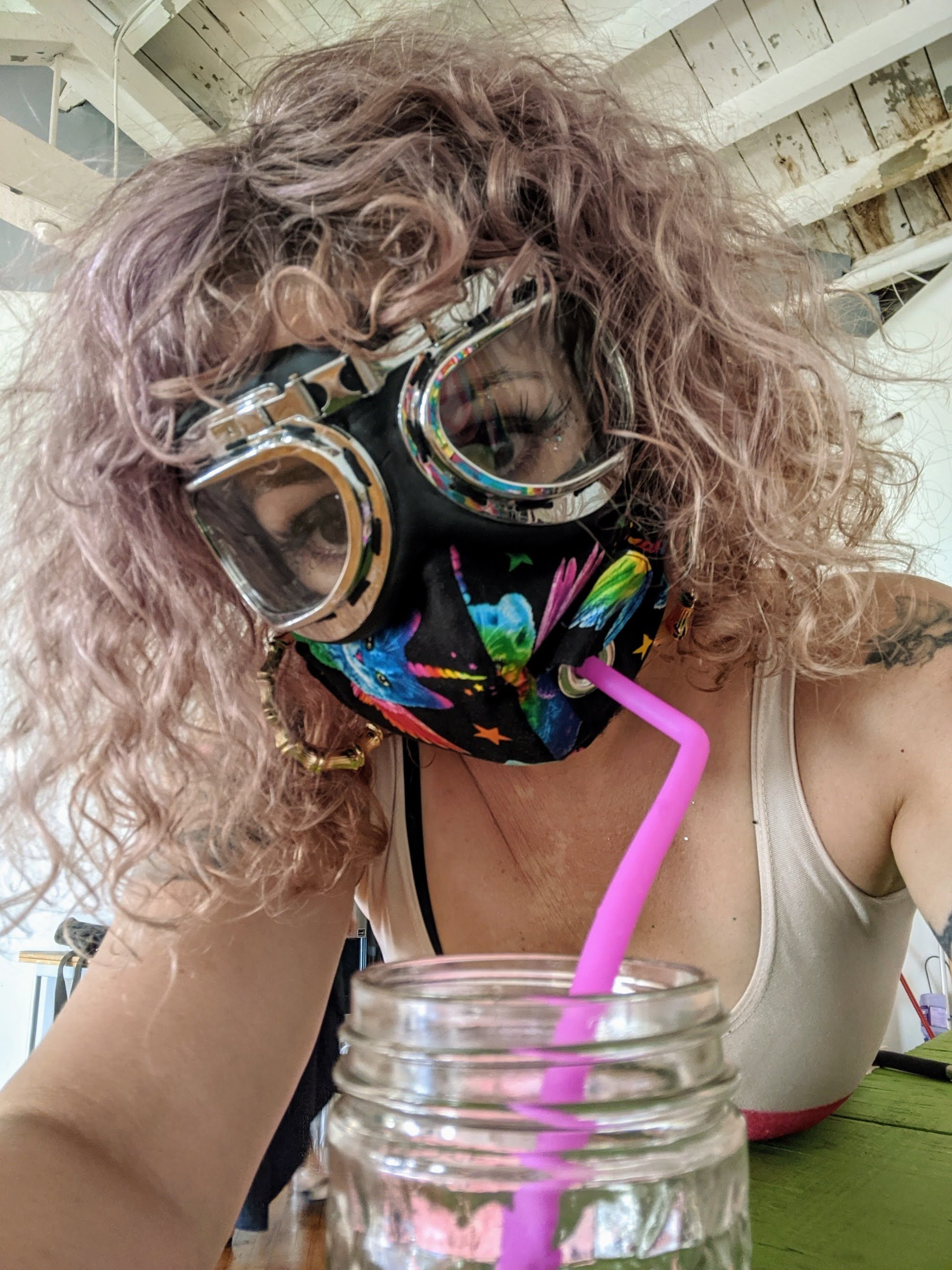 girl with drink and mask